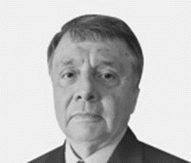 A man in suit and tie with short hair.