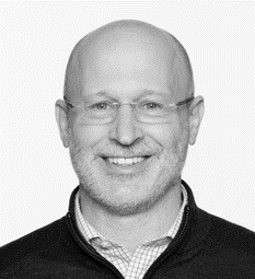 A man with glasses and bald head wearing a black sweater.